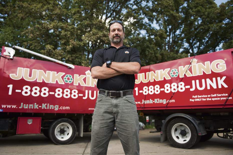 owner in front of Graham Junk Removal trucks