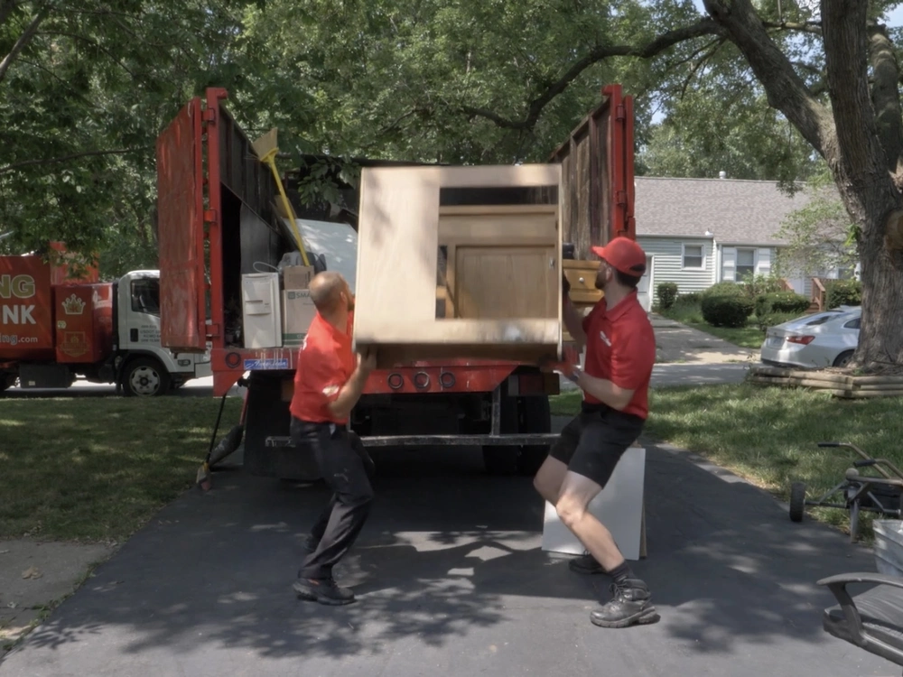 junk king burlington loading a cabinet from an estate cleanout